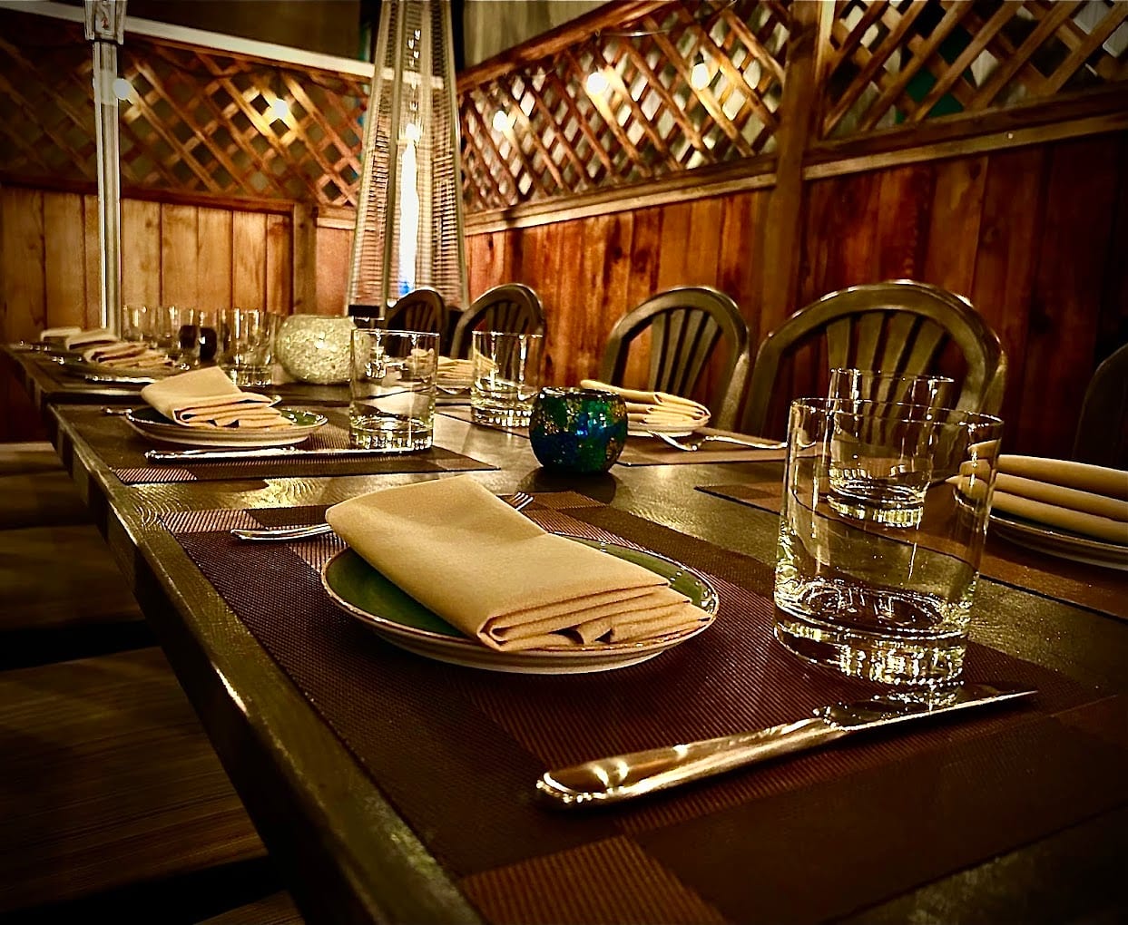A long wooden table set with napkins and glassware in Decant's warm, wood-panelled dining room